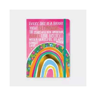 Caderno cor-de-rosa com ilustração colorida e texto motivacional na capa