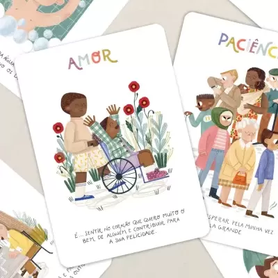 Cartas ilustradas com desenhos de pessoas e texto em português e espanhol sobre uma mesa clara.