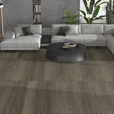 Modern living room with light grey sectional sofa, black coffee table, wooden floor, and plants