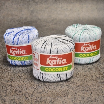 Três novelos de linha branca com riscas coloridas da marca Katia Coconut