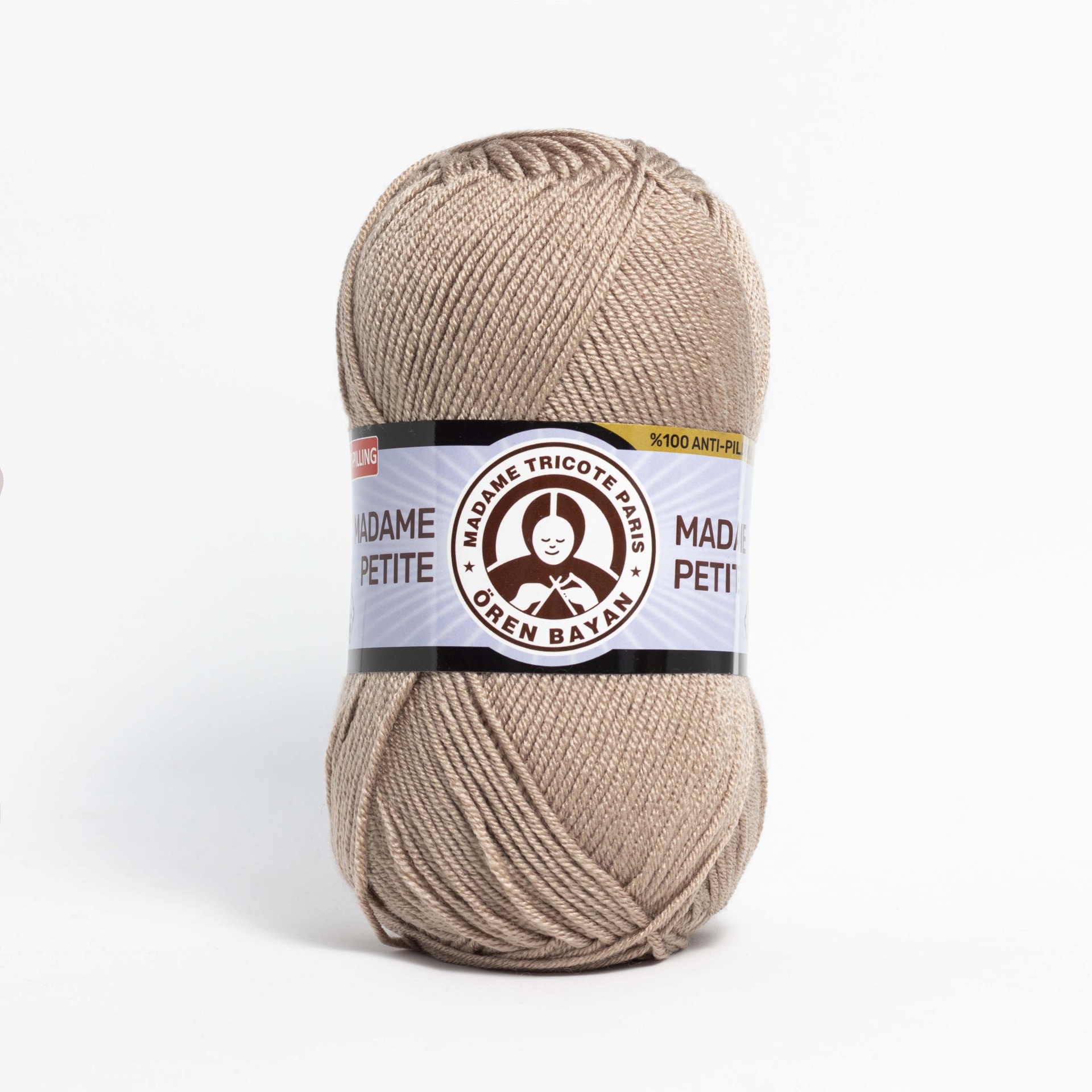 Novelo de lã bege Madame Tricote Paris Orlen Baby com rótulo branco e preto