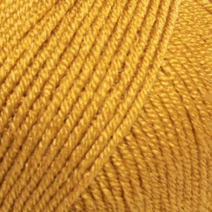 Fio de lã amarelo enrolado em bola com textura macia