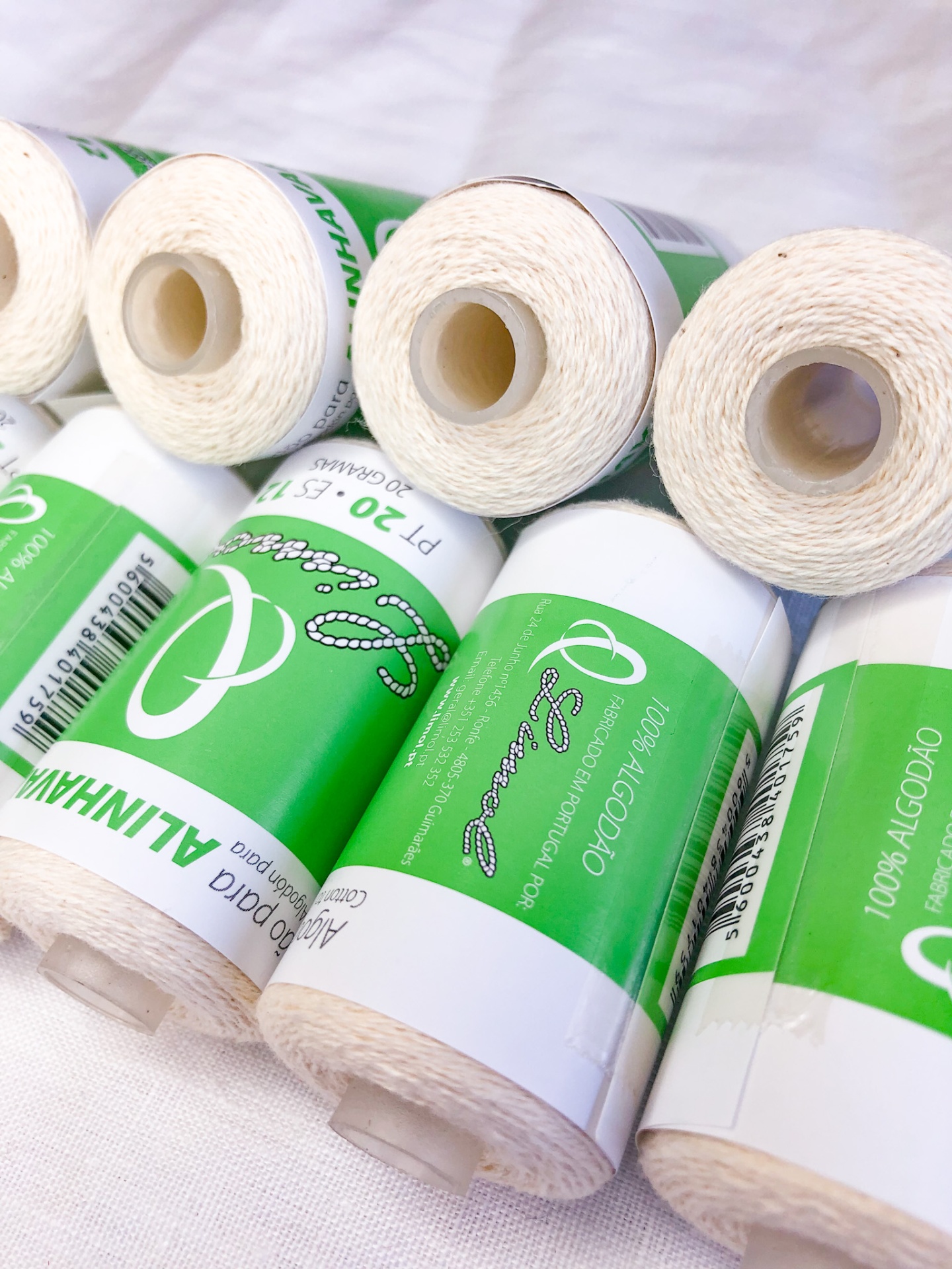 Rolos de linha branca de algodão algodão com etiquetas verdes