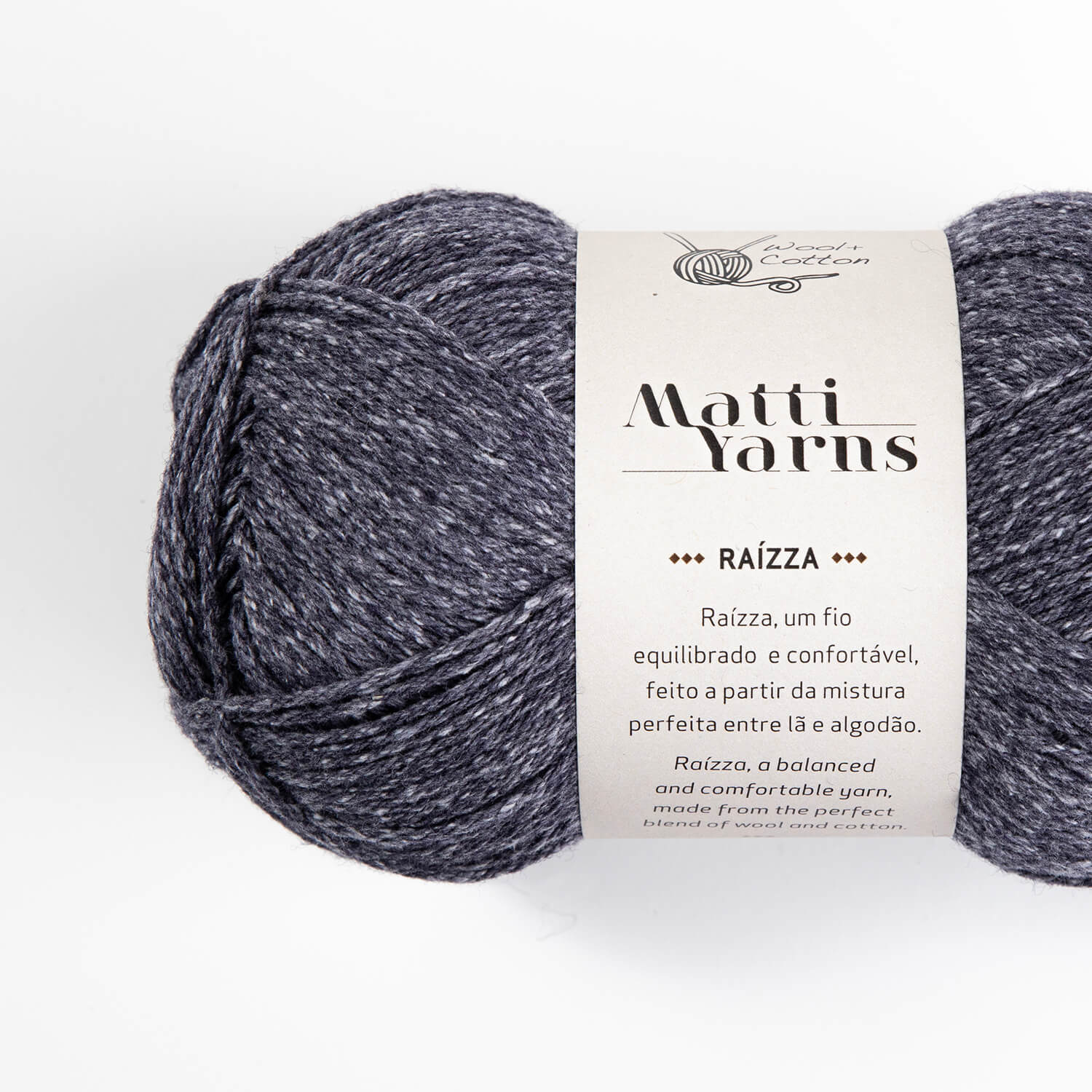 Novelo de fio cinza azulado mesclado com etiqueta branca e texto informativo