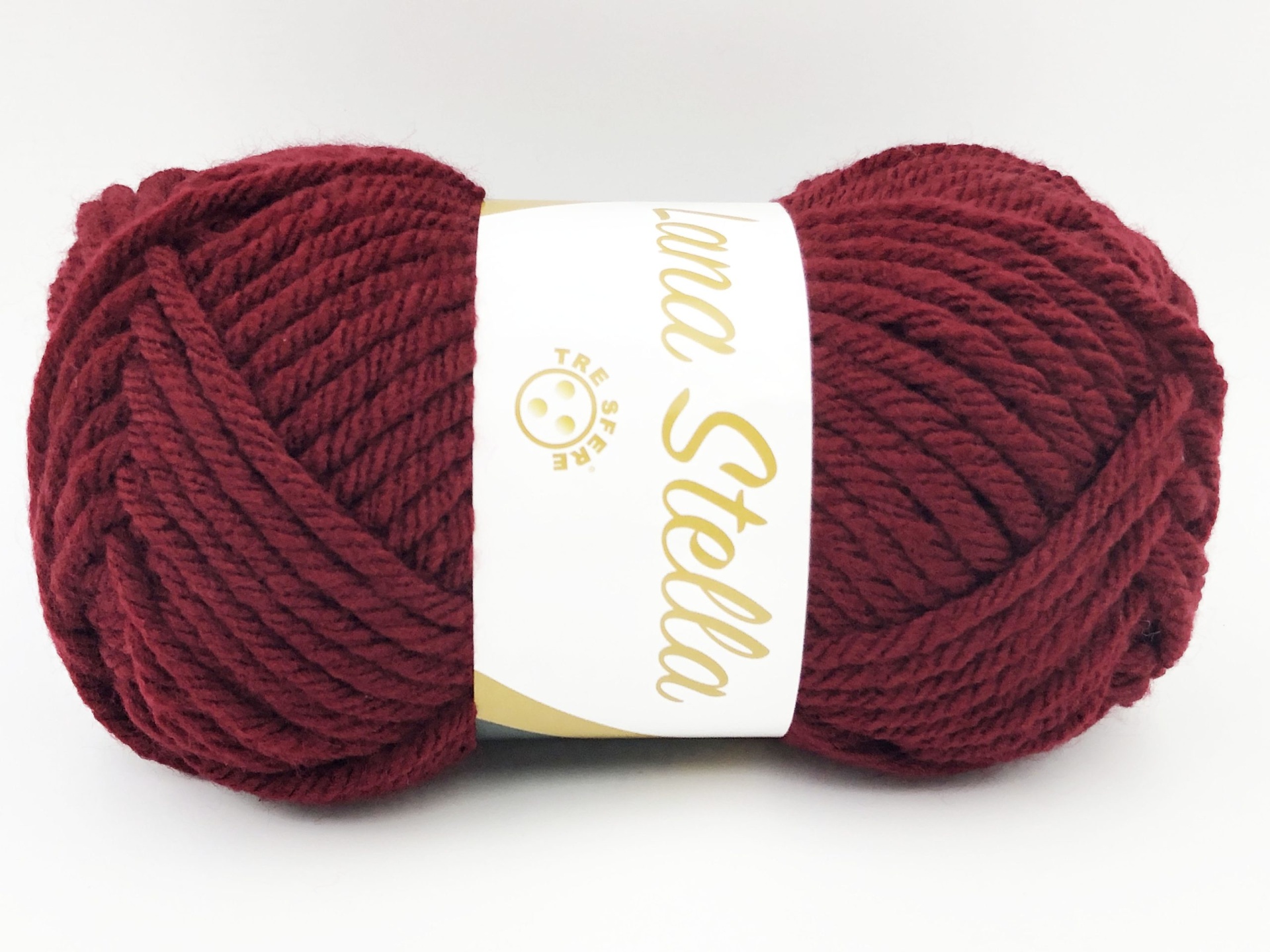 Novelo de lã grosso bordô com rótulo branco e dourado