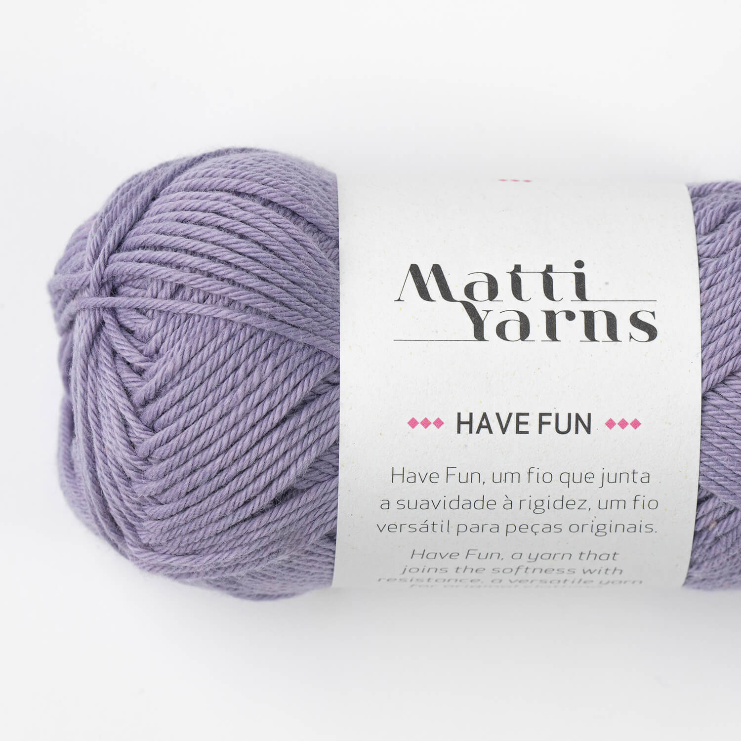 Skein of lilac yarn with a white label showing 'Matti Yarns HAVE FUN' text