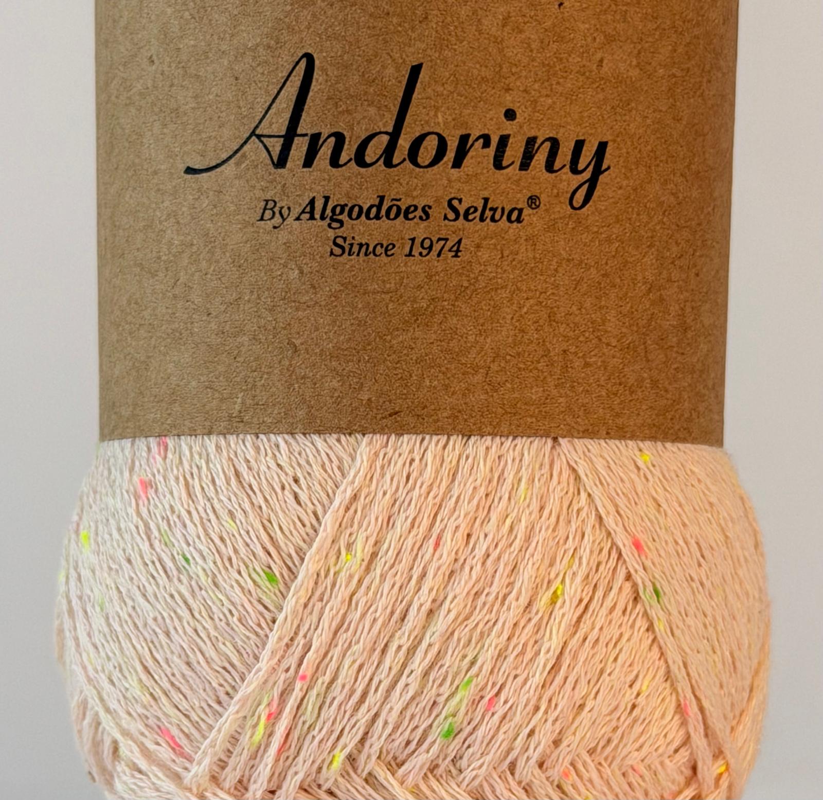 Novelo de fio de algodão com manchas coloridas e etiqueta com o texto Andoriny desde 1974