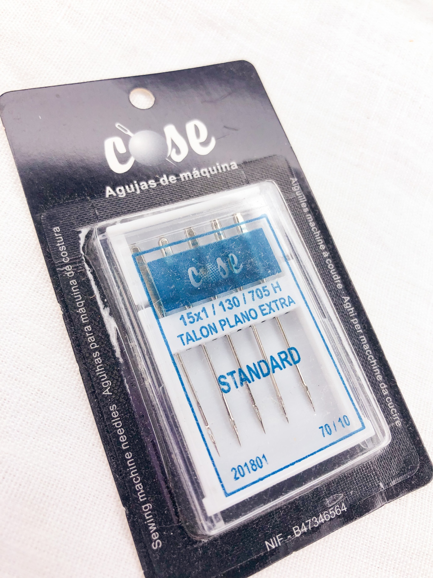Embalagem de agulhas para máquina de costura da marca cose com texto azul