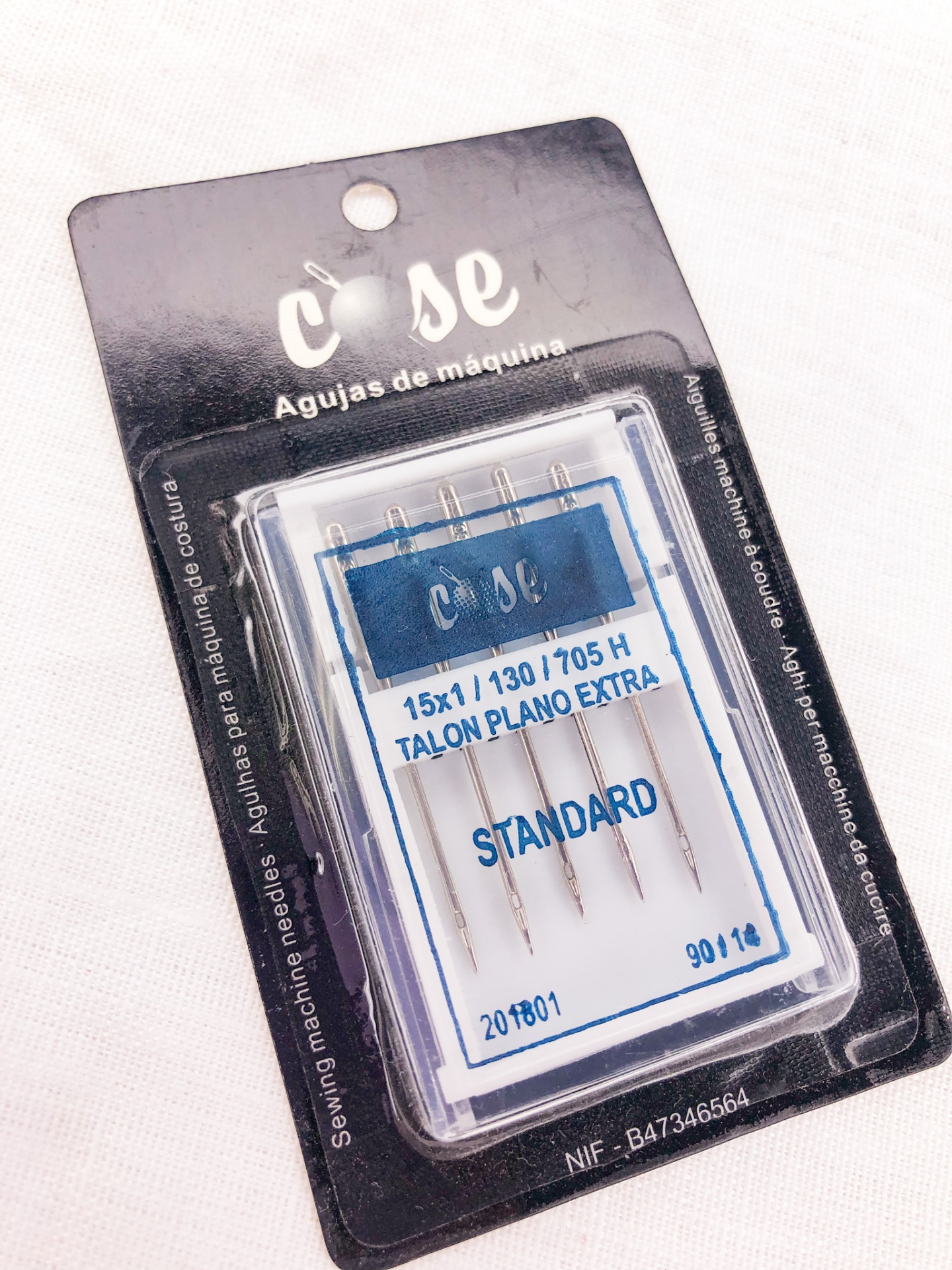 embalagem de agulhas para máquina de costura com cinco agulhas e texto em português e espanhol