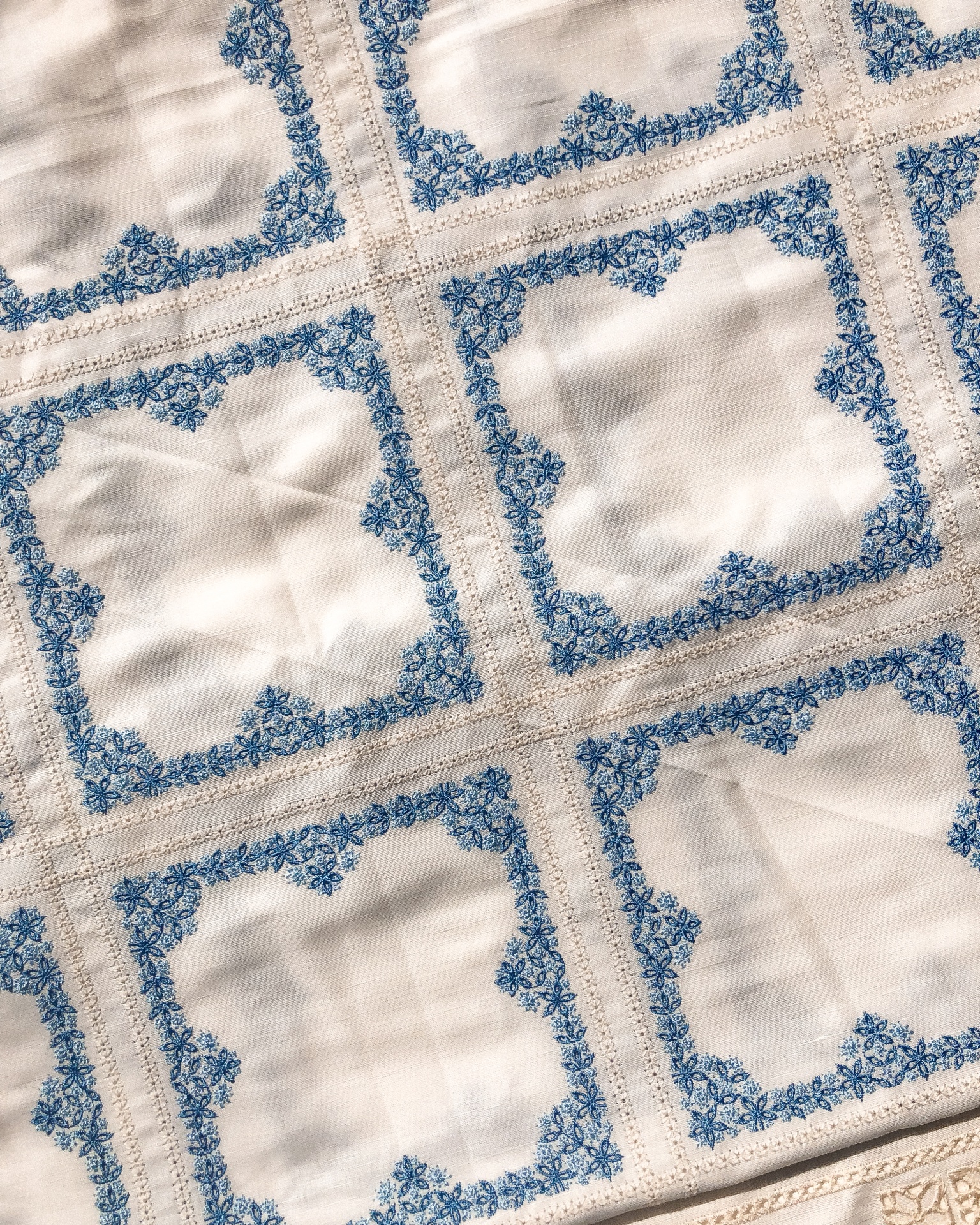 Tecido branco com molduras azuis florais e detalhes castanhos