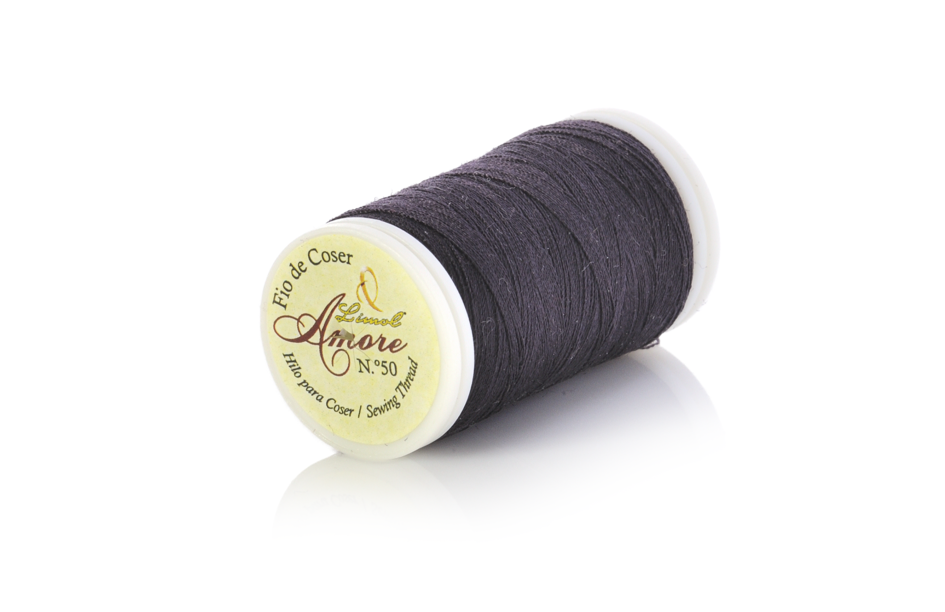 Bobina de linha preta com rótulo amarelo sobre superfície branca