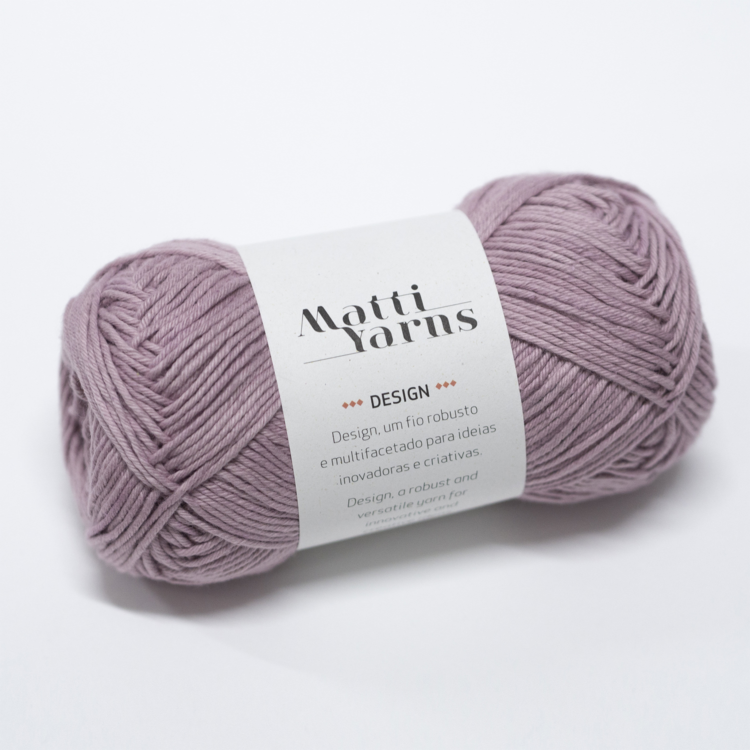 Novelo de lã lavanda com rótulo branco e texto preto 'Matti Yarns DESIGN' em fundo branco
