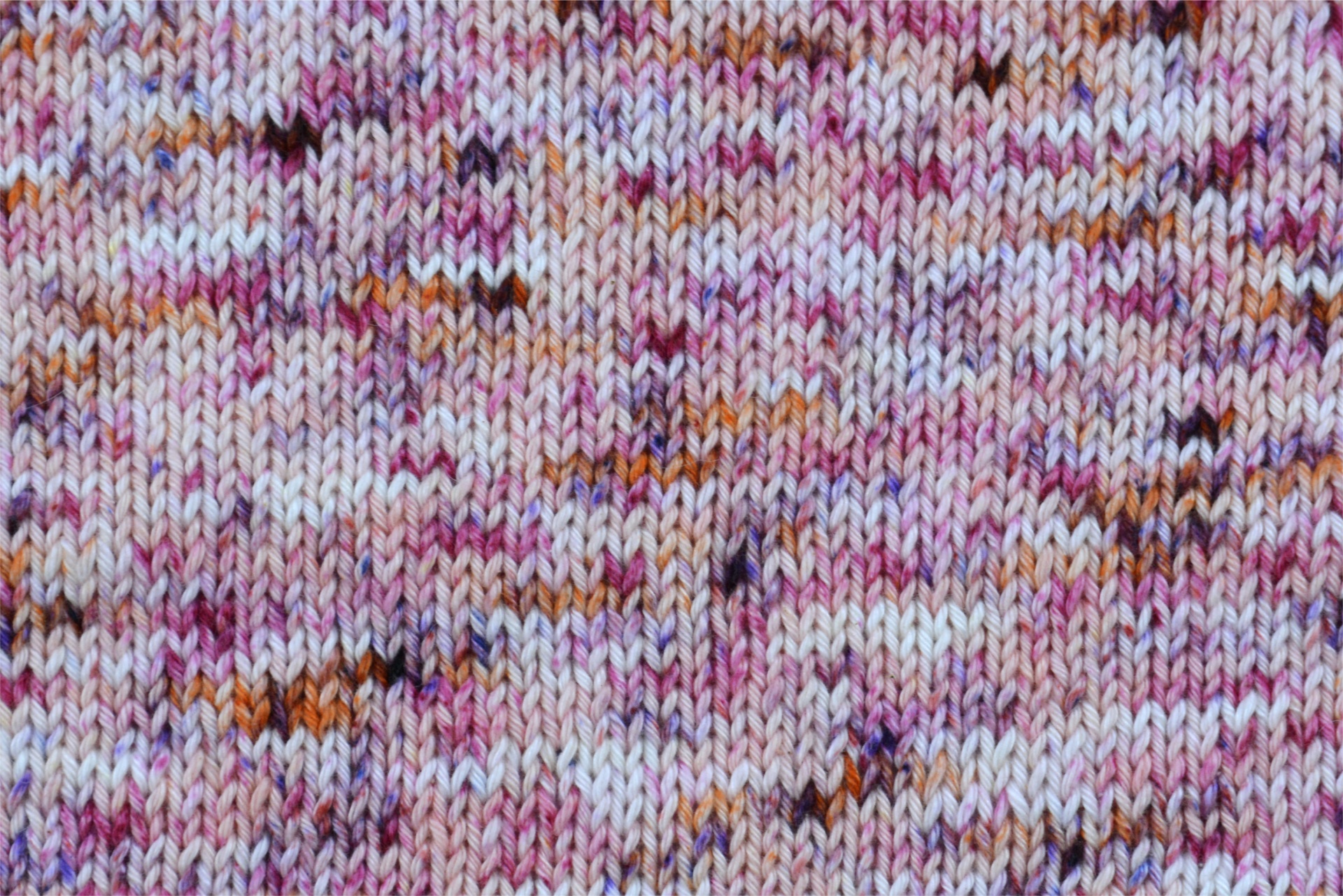 Tecido de malha colorida com padrão em tons de rosa e branco