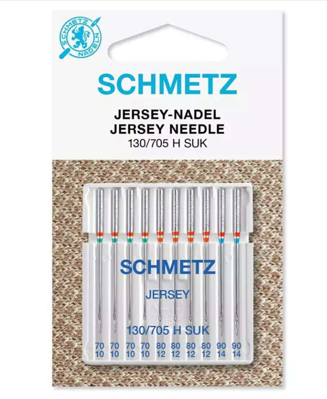 Agulhas de máquina de costura Schmetz Jersey Needle em embalagem com fundo de tecido