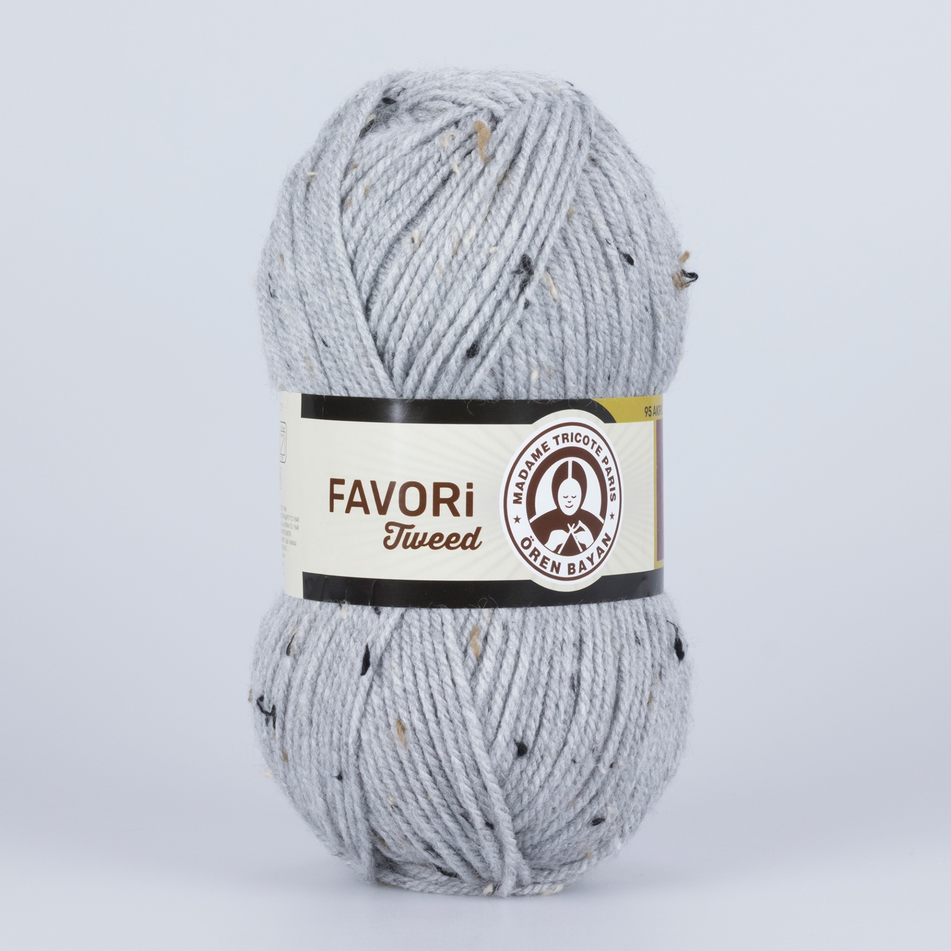 Novelo de lã cinzenta clara tipo tweed com pequenos pompons coloridos e etiqueta identificativa.