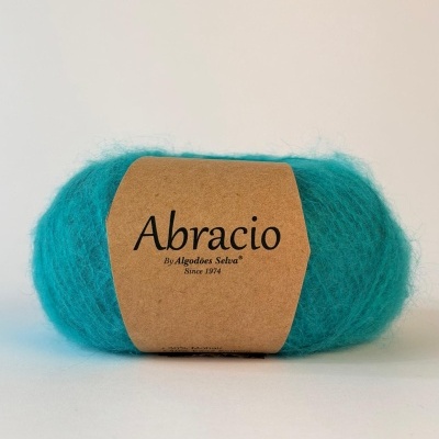 Novelo de lã azul turquesa com etiqueta castanha de papel Abracio