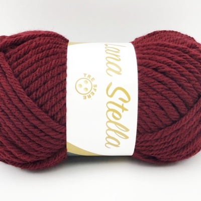 Novelo de lã grosso bordô com rótulo branco e dourado