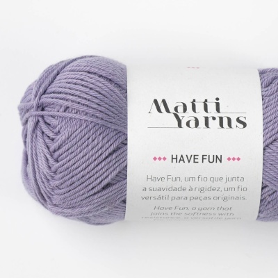 Skein of lilac yarn with a white label showing 'Matti Yarns HAVE FUN' text