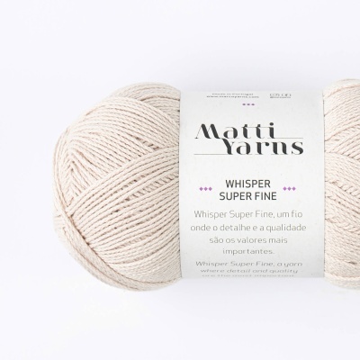 Novelo de fio bege claro da Matti Yarns Whisper Super Fine com rótulo branco.