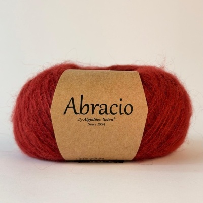 Novelo de lã vermelha com etiqueta Abracio