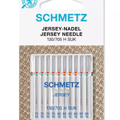 Agulhas de máquina de costura Schmetz Jersey Needle em embalagem com fundo de tecido