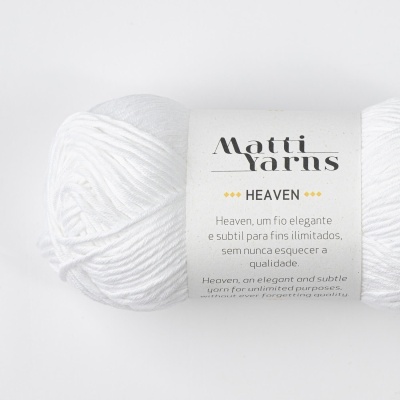 Novelo de fio branco da marca Matti Yarns modelo HEAVEN com rótulo explicativo em fundo branco.