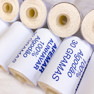 Rolos de algodão 100% com etiquetas e texto azul