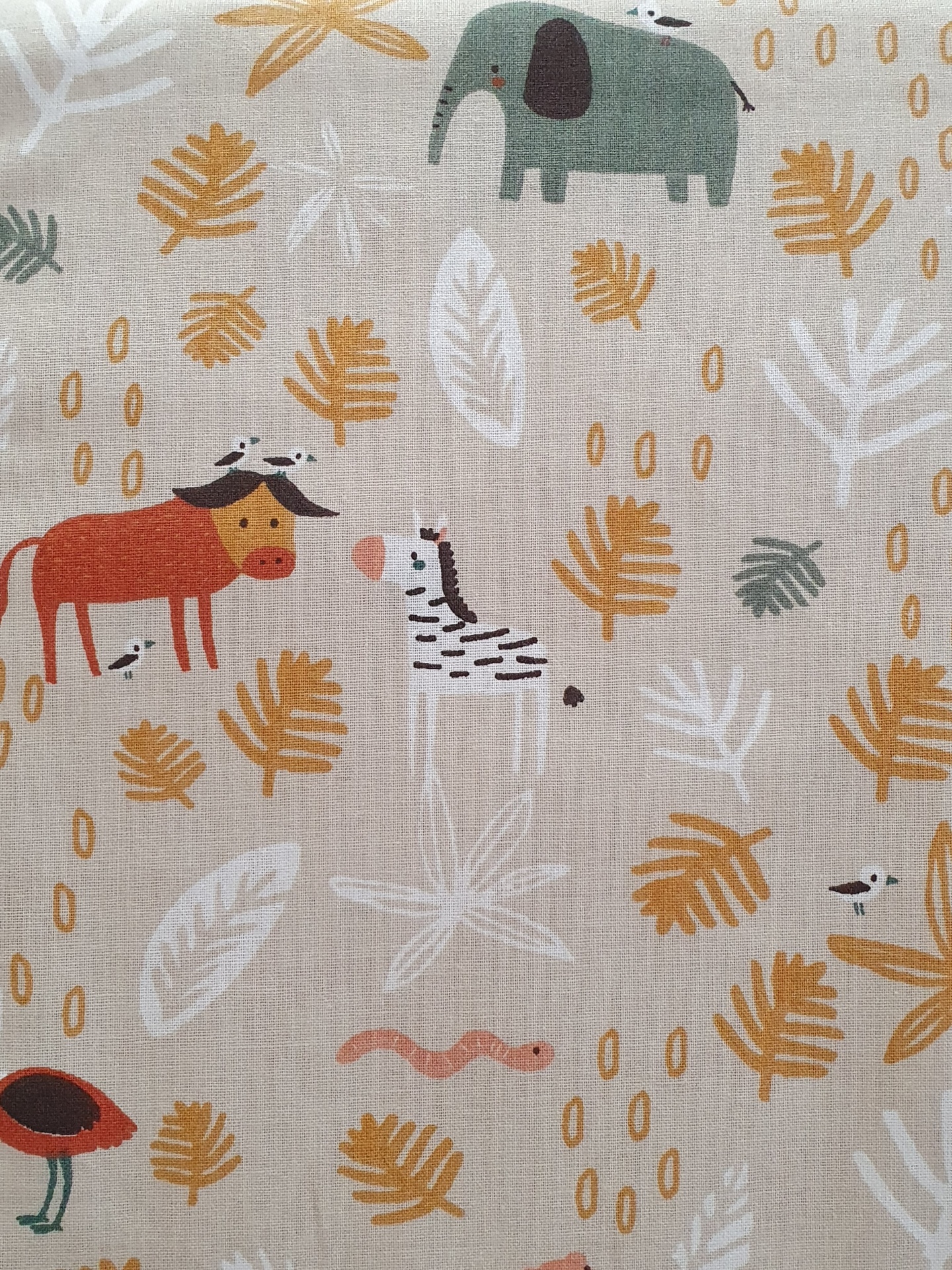 Little Jungle Tecido bege com padrões de animais coloridos e folhas para uso infantil