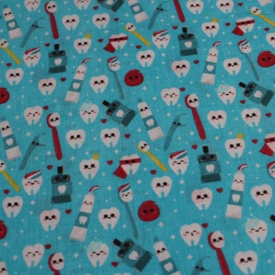 tecido azul com padrão de desenhos de dentes, escovas de dentes e produtos dentários