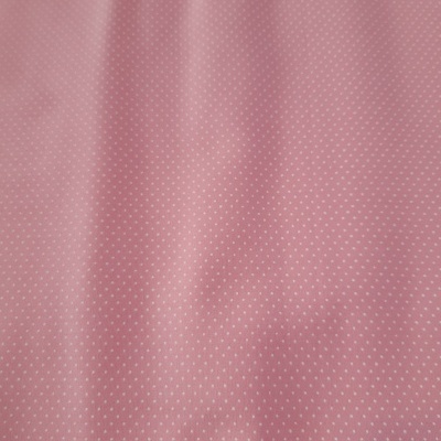 Tecido rosa com padrão de pequenos pontos brancos