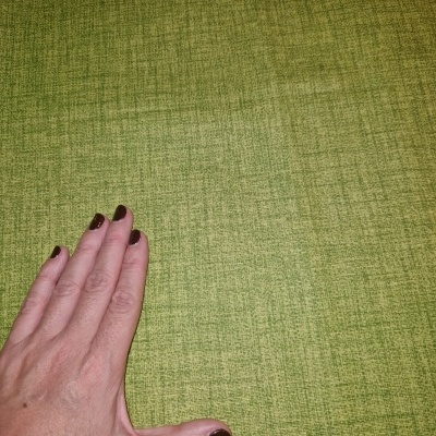 Mão sobre tecido verde texturizado