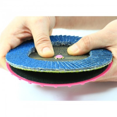Disco de lixa abrasiva circular azul com suporte rosa segurado por mãos