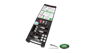 Caixa preta aberta com componentes metálicos e documento, logótipos JAGUAR e LAND ROVER ao fundo