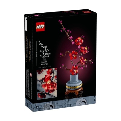 Caixa de LEGO com ramo de flores vermelhas e rosas em vaso cinza sobre fundo preto