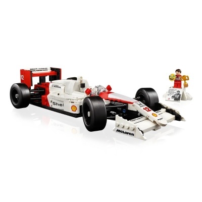 Modelo de Fórmula 1 McLaren branco e vermelho com mini-figura de piloto e troféu em fundo branco
