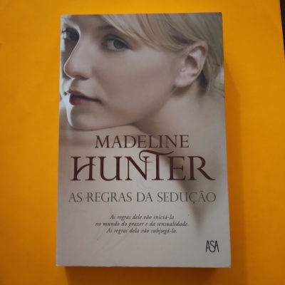 Capa do livro 'As regras da sedução' de Madeline Hunter com rosto de mulher loira e texto em português