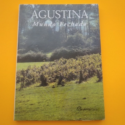Livro Agustina Mundo Fechado com capa de vinha em fundo laranja.