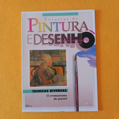 Revista sobre técnicas de pintura e desenho com imagem de quadro e pincel