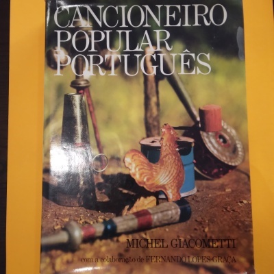Capa de livro com título e objetos tradicionais portugueses em fundo ao ar livre.