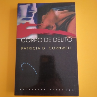 Capa do livro Corpo de Delito de Patricia D. Cornwell com ilustração de duas faces e risco vermelho