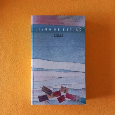 Livro 'LIVRO DE ESTILO' da publicação 'PÚBLICO' sobre fundo laranja