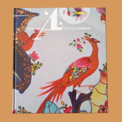 Livro com capa dura ilustrada com aves e flores coloridas e texto Colecção António Olmos