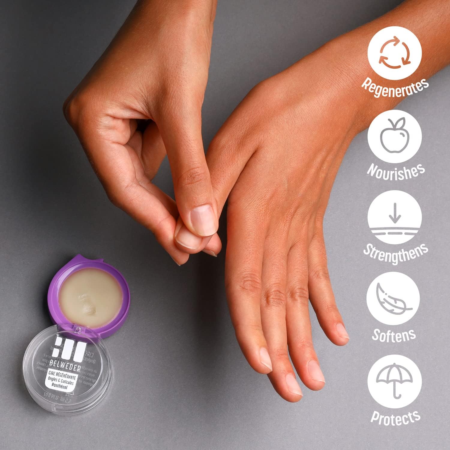 Cera Regeneradora de Cutículas Belweder com Pantenol 5,5ml - Fortalece e Repara Unhas Danificadas (Envio em 3 dias) Creme para mãos em embalagem redonda com tampa roxa ao lado de mãos femininas sobre fundo cinza.
