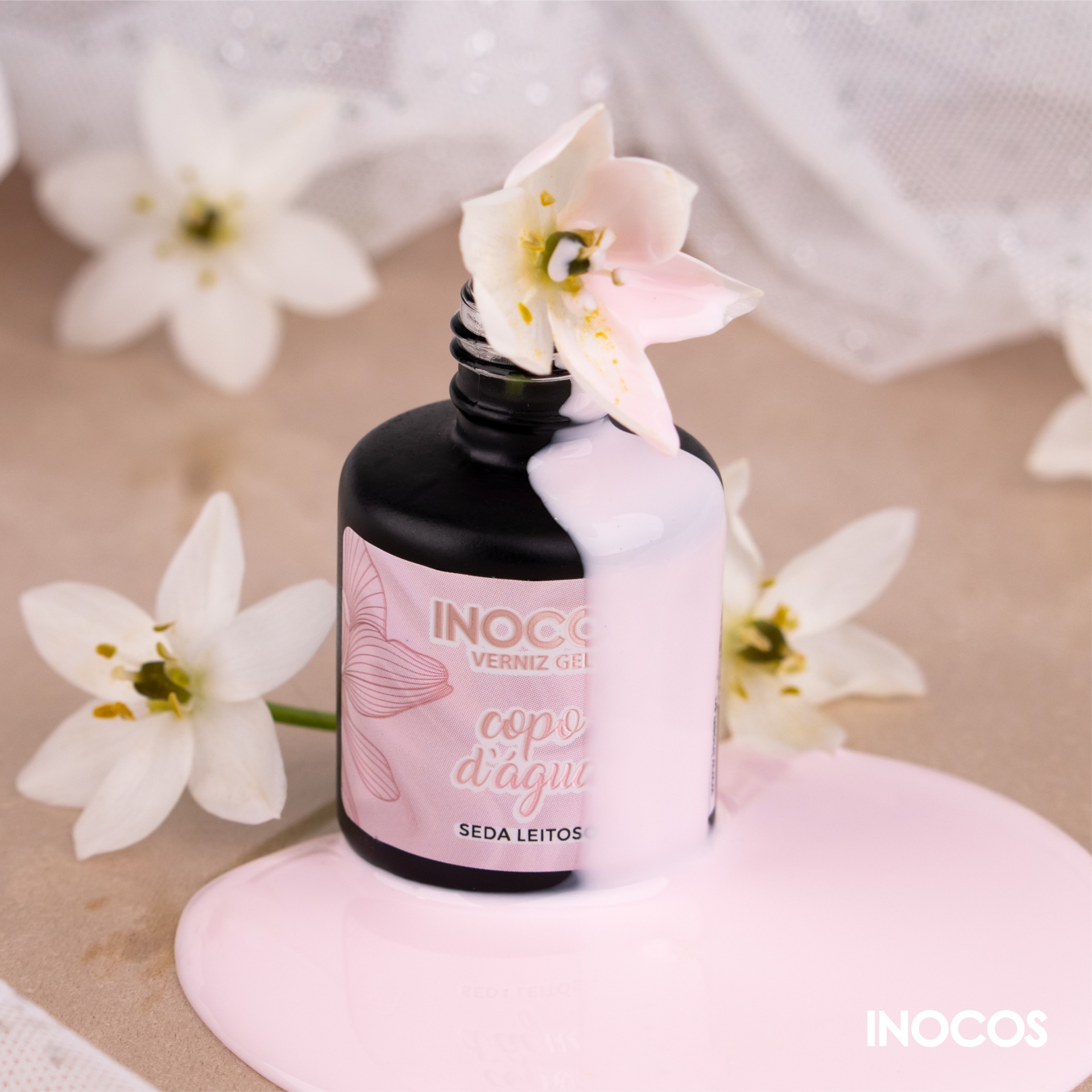 Verniz Gel Inocos – 324 - Copo D'Água Frasco preto de verniz gel INOCOS com rótulo rosa e verniz rosa derramado