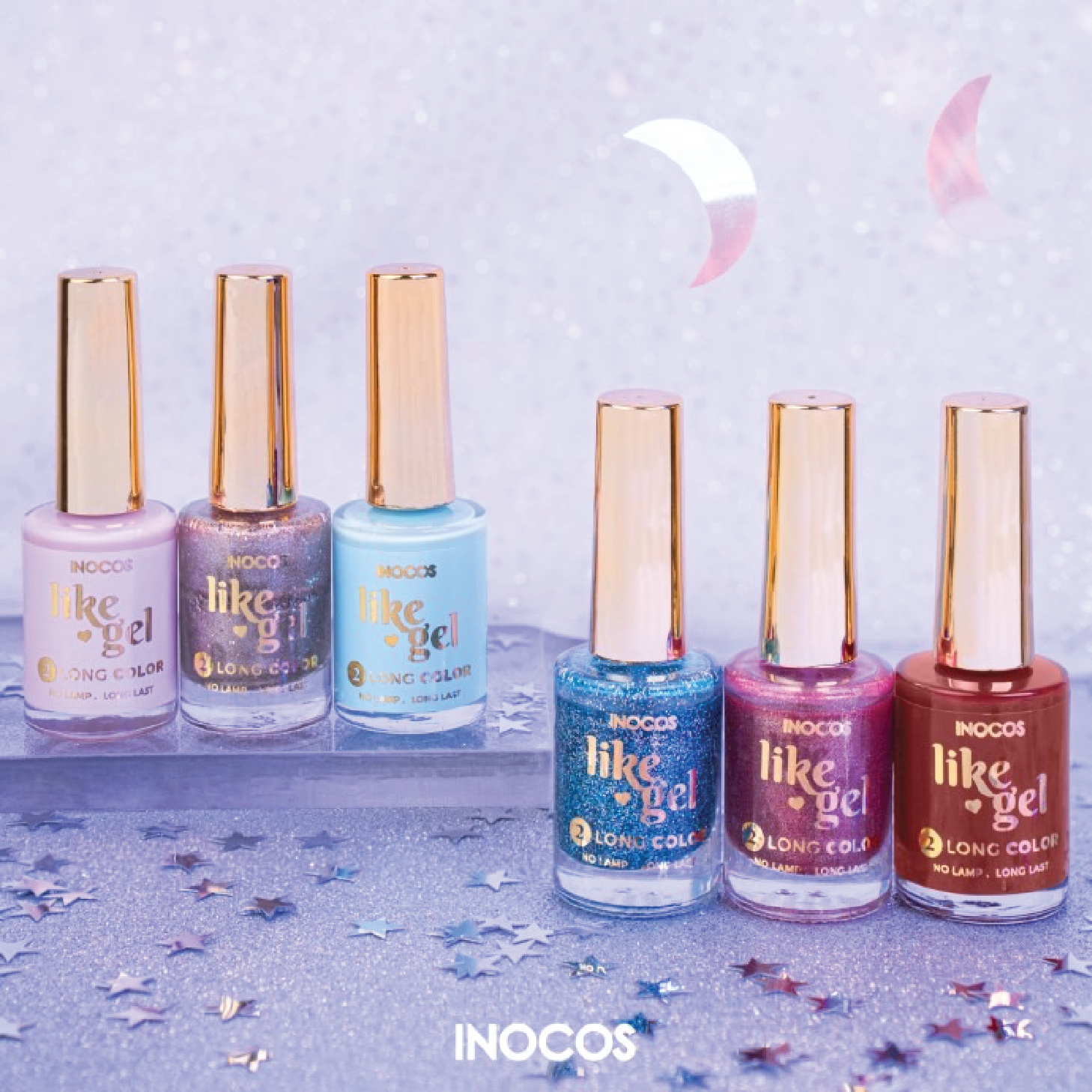 Like Gel Inocos - Coleção "A Million Dreams" Seis frascos de verniz gel INOCOS em várias cores com tampas douradas num fundo lilás com estrelas prateadas