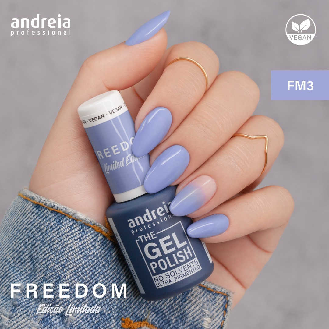 The Gel Polish Andreia FM3 - Lilás (FREEDOM) Mão com unhas lilás fosco segurando verniz em gel azul escuro da andreia professional FREEDOM FM3