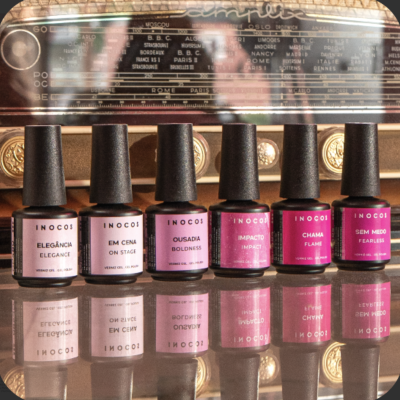 Seis frascos de verniz de unhas INOCOS em diferentes tons de rosa e vermelho