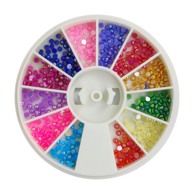 Caixa redonda branca com brilhantes coloridos organizados em divisórias