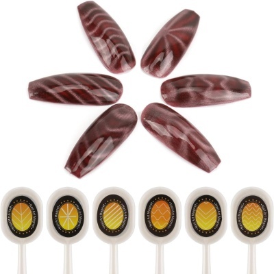 Amostras de unhas postiças vinho com padrão marmoreado branco e descritores circulares brancos com padrões amarelos e laranjas