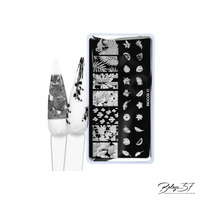 Placa de carimbo com desenhos florais e folhas e dois cones de unhas decoradas em preto e branco